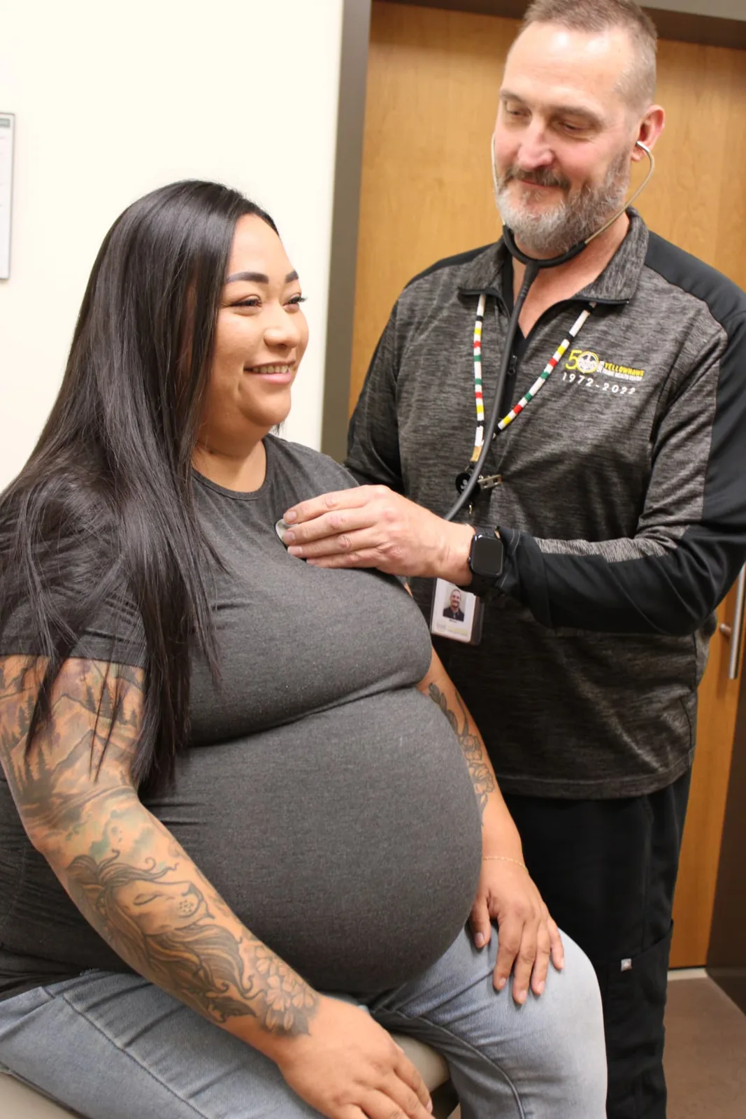 A Yellowhawk provider listening to an expectant mother's heartbeat during a prenatal visit