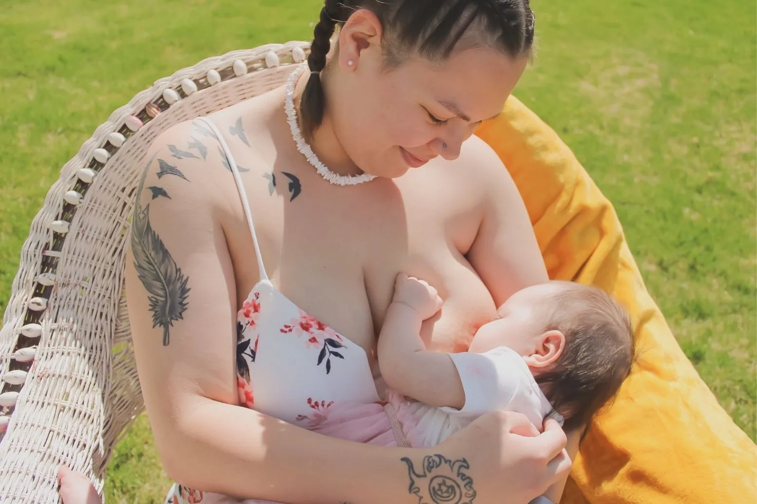 A parent holding and feeding their baby